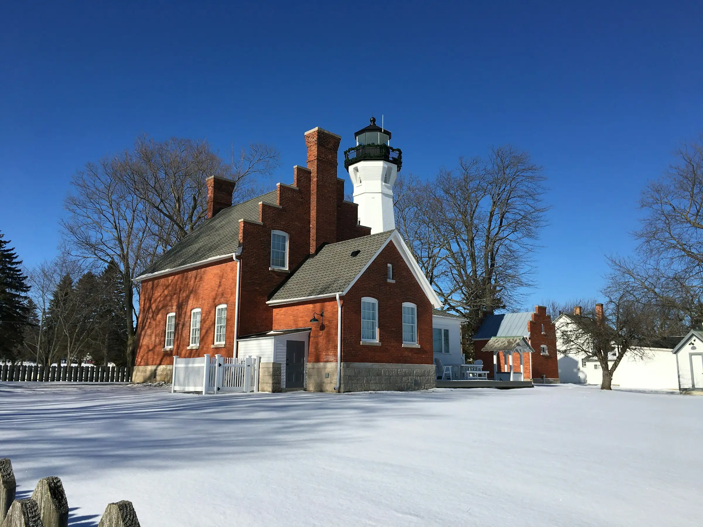 Port Sanilac lighthouse and keeper’s house in winter snow, Lake Huron
