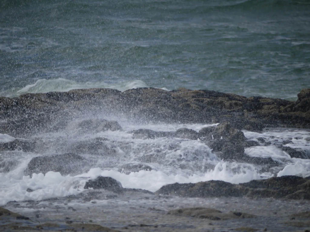 Storm waves breaking over a rocky shore